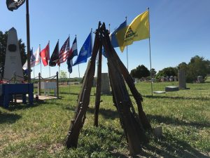 Rifles with flags in the background